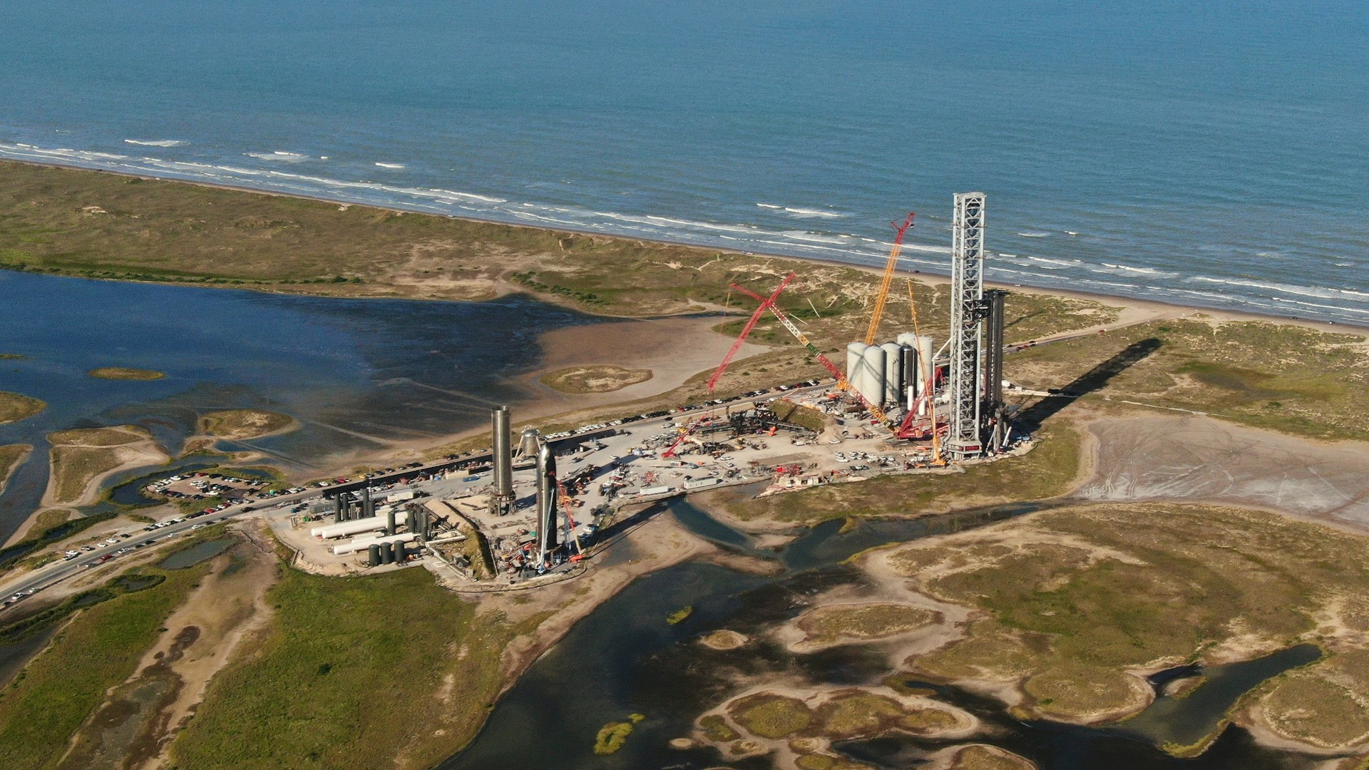 Starbase launch site with rockets and cranes